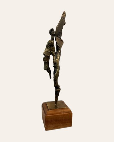 Tall bronze figure on a wooden plinth